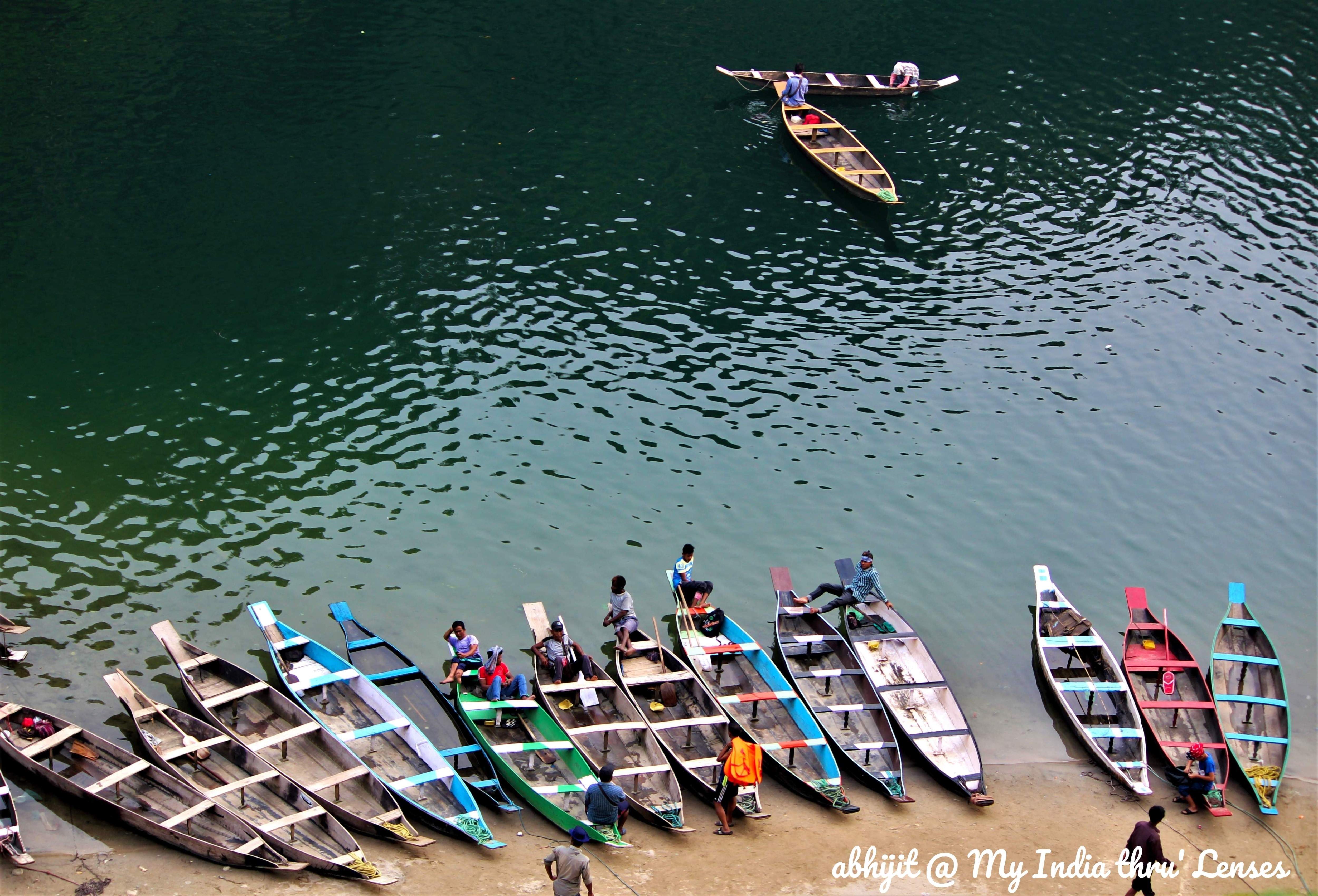 Colourful Boats look awesome on a Greenish background of Umgot water
