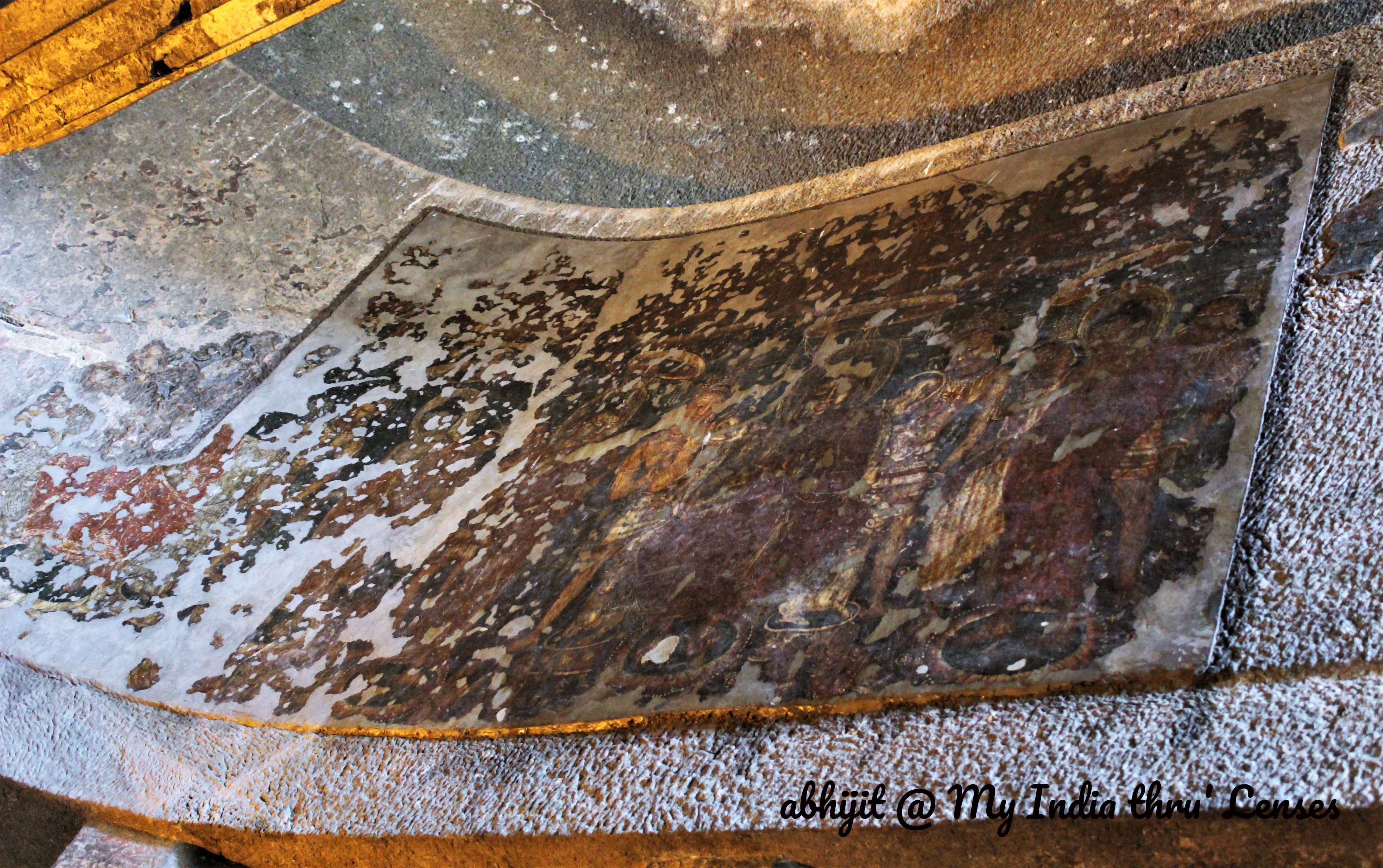 Buddhas in orange robes and protected by chatra or umbrellas (Cave 9)